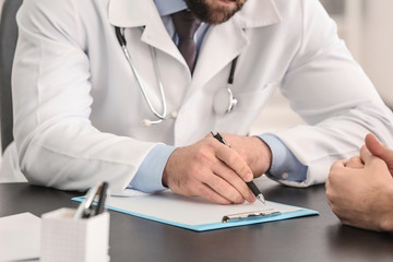 Doctor consulting male patient in clinic