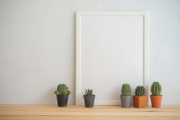 Photo frame and cactus pots mockup with white wall background, creative ideas slow life concept
