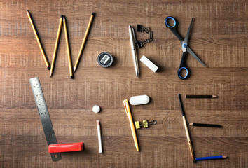 Words WORK and LIFE made of stationery on wooden background