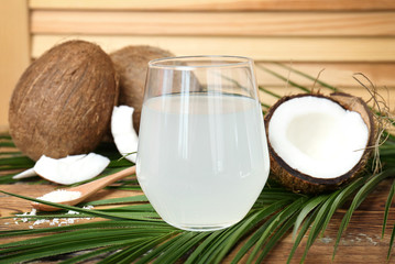 Glass of coconut water on wooden table