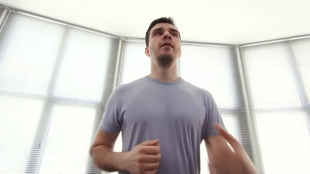 portrait man over 30, on a running simulator,gym