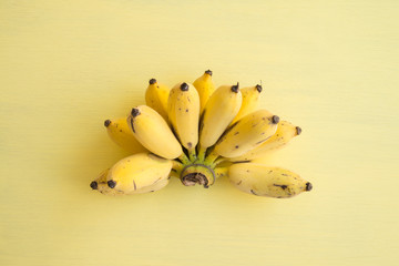 Flat lay of banana bunch on yellow background - Creative ideas summer holiday concept © pla2na