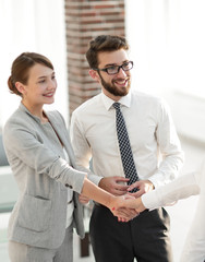 senior assistant looks at the handshake business partners.