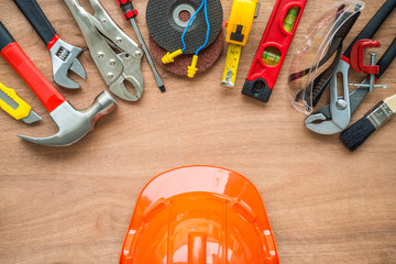 Flat lay, set of construction hardware tools building, repair, painting accessories on wooden board background