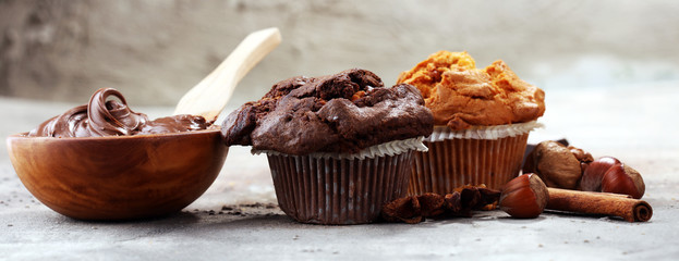 Chocolate muffin and nut muffin, homemade bakery on grey background