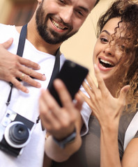 Couple standing in a city during there trip.