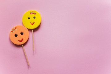 Round smiling lollipops peach and yellow color