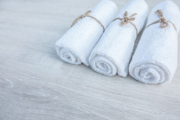 Fototapeta na wymiar Beautiful spa composition white towel on wooden table.