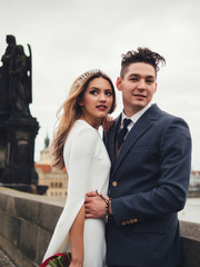 Groom and bride in charles bridge. winter wedding in Prague