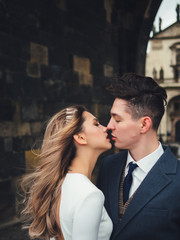 Groom and bride in charles bridge. winter wedding in Prague