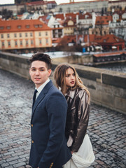 Fototapeta na wymiar Groom and bride in charles bridge. winter wedding in Prague