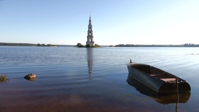 Warm July morning on the Uglich reservoir. View of the flooded bell tower. Kalyazin, Russia