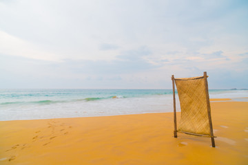 Blue waves of the ocean and yellow sand of the beach.