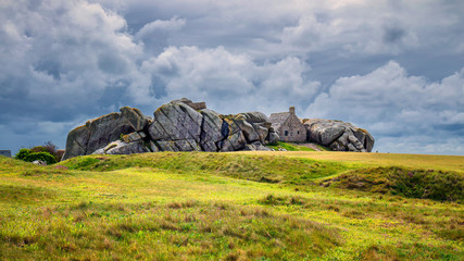 House between the rocks in Meneham village, Kerlouan, Finistere, Brittany (Bretagne), France