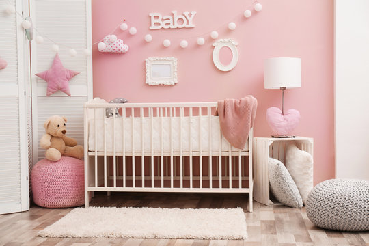 Beautiful interior of baby room with crib © Africa Studio