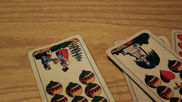 tracking shot on playing cards, gambling addiction
