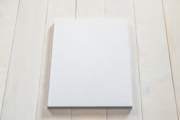 Blank book cover mockup template with page front side on white surface on wood table