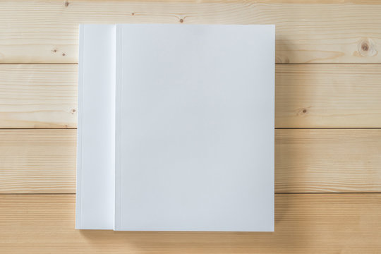 Two Blank A4 size book cover mockup template with page front side on white surface on wood table