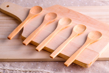the wood spoon on brown mat