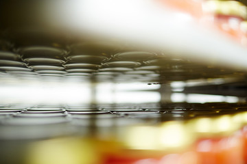 Reflection of tops of cans with caviar or other seafood ready for sale