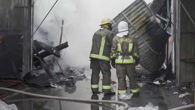 Firefighters on fire. Fireman extinguishes the fire with water. External market is on fire.