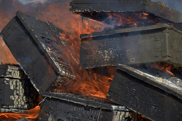 Burning wooden military crates from ammunition. Burning fire. The smoldering fireplace.