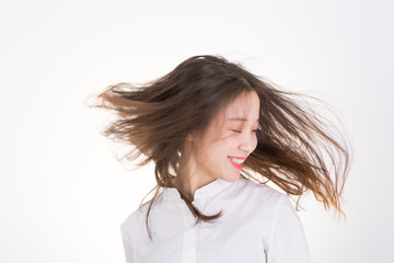 Young Woman Dancing. Portrait of pretty young woman flinging long black hair into air.