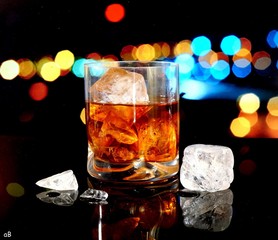 Glass of whiskey with lats of bokeh.