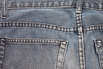 Fototapeta premium Jeans in the middle of the back, seen at the edge of the bag on the two sides.