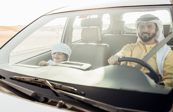 father and son spending time,driving  in the desert
