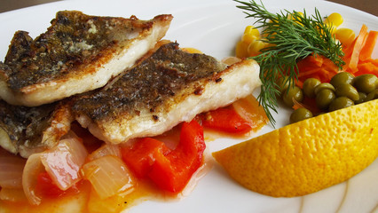 Tasty fried fish with vegetables.