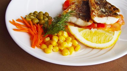 Tasty fried fish with vegetables.