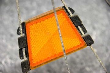 dirty reflectors of an old bicycle attached to the spokes 