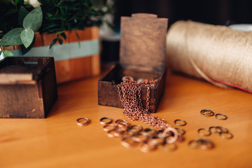 Needlework, metal rings and wooden box on table