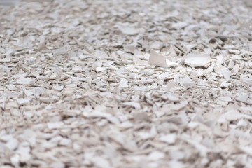 a large number of white fragments of toilets sinks and plates.