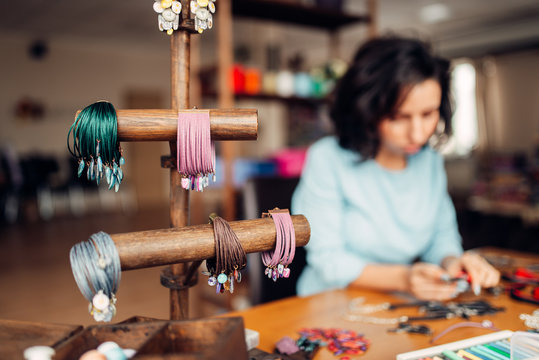 Needlework tools, master at workplace in workshop