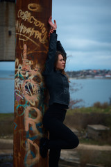 Young slim brunette on a ruins of abandoned building