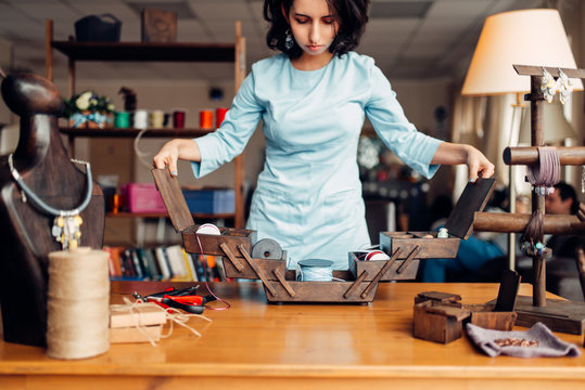Needlework, female master at workplace in workshop