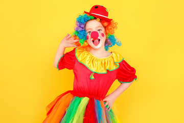 Portrait of girl clown, tongue out, looking at camera
