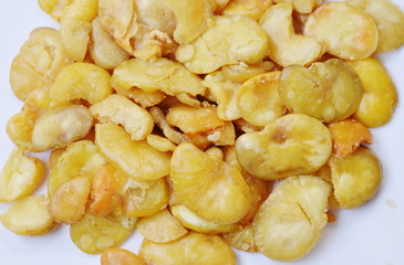 baked salt broad beans on white background
