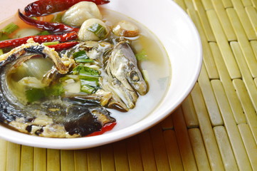 boiled smoked dry snake head fish in spicy and sour soup on bowl