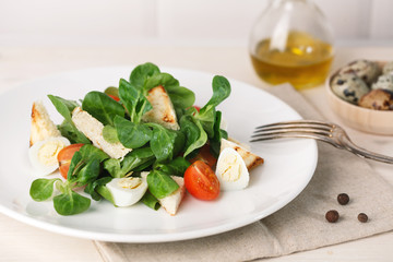 salad with quail egg, cherry tomato, crackers and corn salad on white background