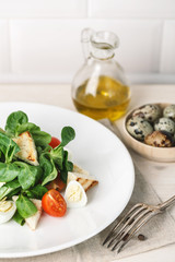 salad with quail egg, cherry tomato, crackers and corn salad on white background