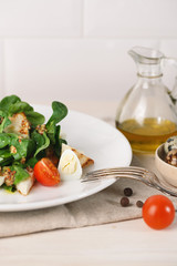 salad with quail egg, cherry tomato, crackers and corn salad on white background