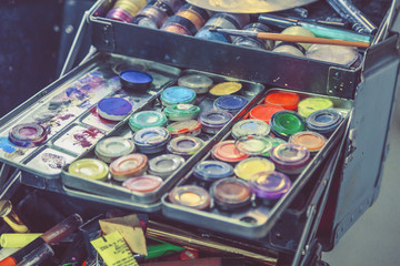 cosmetics and makeup brushes in the dressing room near the mirror close-up