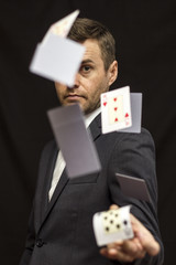 Man with flying playing cards