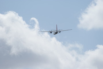 two-engined propeller airplane flying away
