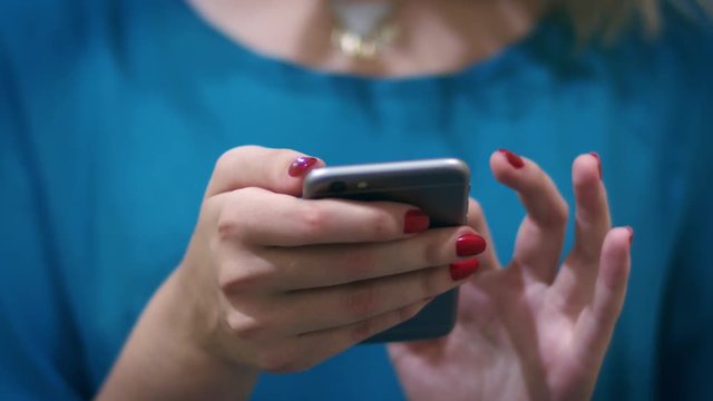 Woman hand typing mobile message on screen smartphone. Close up female hands holding smartphone and browsing website
