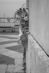 Woman in jester's costume, mask and hat at Carnival of Venice