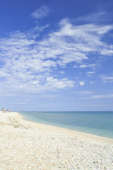 beach of marotta in the italian region of marche during summer with parasols and clouds